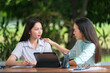 © EduLife Photos - A young Asian college student meets her teacher advisor or a tutor to discuss the academic project