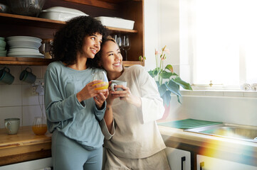 Lgbt couple, coffee and kitchen with smile for connection, romantic or relationship happiness. Lesbian woman partner, apartment and freedom hug for equality conversation, together or diversity pride