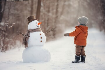 child decorating a snowman
