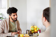 © Johnér - Heterosexual couple sitting at table and having breakfast