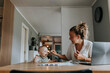 © Johnér - Multitasking mother taking care of baby and working from home