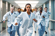 © VisualProduction - Hospital emergency team rushing. Team of doctors, nurses and medical professionals running down a modern hospital corridor in an emergency calling
