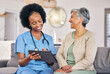 © Phindulo T/peopleimages.com - Doctor, senior woman and tablet for consulting, results and happy for good news on sofa in nursing home. Elderly person, African nurse or medic with digital touchscreen for smile, analysis and report