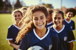 © photobuay - Teenage Girls' Soccer Team Embracing the Game in Blue Kits on the School Soccer Field. created with Generative AI