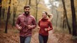 © JW Studio - Smiling young active couple jogging together in the autumn natural park, with copy space.