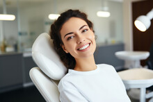Happy Female Patient In Dental Chair Waiting To Be Checked By A Dentist. Healthy White Teeth And Perfect Smile, Healthcare.
