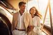 Lovely couple dressed in white on yacht deck, sailing in the sea. Handsome man and beautiful woman having romantic date. Luxury travel concept.