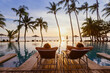 © Song_about_summer - beach travel, couple relaxing on tropical beach at sunset in hotel, vacation and tourism