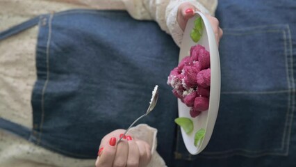 Wall Mural - Italian gnocchi. Traditional Italian food in a bowl is held by a woman in an apron. Handmade potato balls with parmesan and beets. Food for vegetarians and lovers of Italian typical cuisine, 4k 