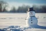 Fototapeta Na sufit - Snowman in a hat and scarf  during sunny weather in the snowy field with distant, blurred trees in the backdrop