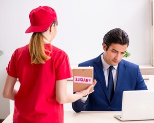 Courier delivering parcel to the office