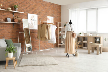 Sticker - Interior of modern boutique with stylish female clothes and accessories