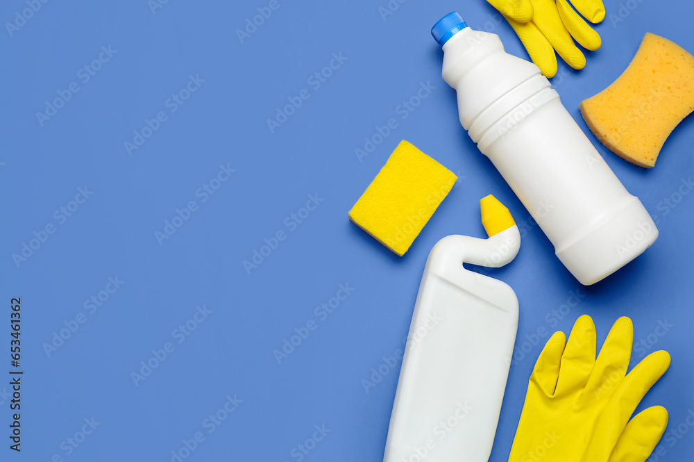 Different cleaning supplies on blue background