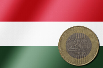 Hungarian forint coin on national flag background