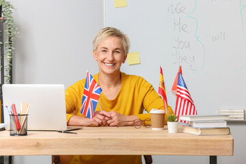 Canvas Print - Female English teacher with UK flag in classroom