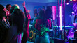 © DC Studio - Young partners dancing in pairs at party, moving on dance floor and partying at nightclub. Couples having fun with romantic slow music at disco party, colorful lights club. Handheld shot.