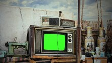 Old TV Green Screen Outside Vintage Devices Zoom In Television. Green Screen Vintage Television And Old Devices On The Exterior Of A House, Cloudy Sky. Zoom In