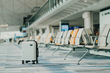 Wall Mural - The suitcases in an empty airport hall, traveler cases in the departure airport terminal waiting for the area, vacation concept, blank space for text message or design