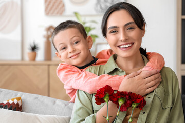 Sticker - Little boy hugging his mother at home, closeup. Veterans Day celebration