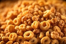 A Captivating Image Captures The Unique Textures And Shapes Of A Mixture Of Whole Grain Cereal, Revealing A Delightful Combination Of Puffed Squares, Golden Rings, And Granola S, Promising