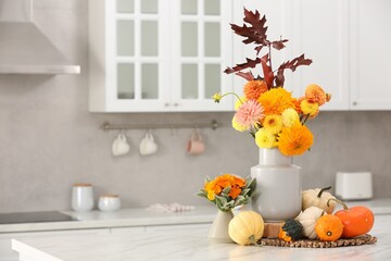 Poster - Beautiful autumn bouquets and pumpkins on marble table in kitchen