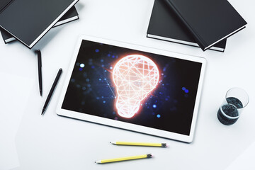 Poster - Creative light bulb hologram on modern digital tablet screen, idea concept. Top view. 3D Rendering