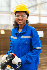 Portrait female professional engineer factory in protective uniform operating machine, Engineering worker in safety hardhat at warehouse industrial facilities, Heavy Industry Manufacturing