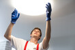 © Angelov - man changing led ceiling lamp in new house