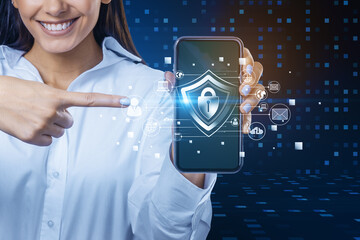 Poster - Attractive young european businesswoman pointing at cellphone with creative glowing padlock hologram on blurry background with various icons. Safety and security concept.
