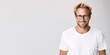 Handsome blond man wearing white t-shirt and glasses. Isolated on white background.