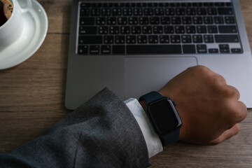 Poster - Man checking time on his smartwatch device Close-up display clock checking lifestyle communication phone mobile touch app technology