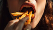 Mouth of young woman eating french fries. Cheat meal concept. Pretty woman eats french fries containing much calories being fast food lover has mouth full of chips