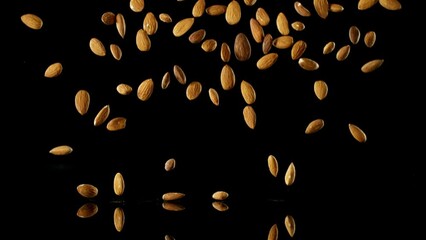 Poster - Super Slow Motion of Falling Almond Nuts with Reflection. Isolated on Black Background. Filmed on High Speed Cinema Camera, 1000fps.