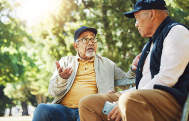 Poster - Senior friends, men and conversation on park bench, bonding and relax outdoor with phone. Elderly people sitting together in garden, communication and serious in nature for retirement in the morning