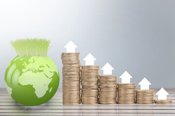 Wall Mural - Growth money concept with coins, globe and arrow