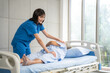 © Bavorndej - Nurse helps senior woman do physical therapy at the hospital bed. Healthcare, Retirement, Volunteer, Caregiver and Lifestyle concept.