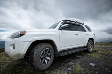 Wall Mural - Off road car on top of high altitude mountain trail, China