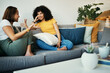 © aLListar/peopleimages.com - Women, friends and conversation in a home with gossip, discussion and happy in a living room. Couch, smile and people on a sofa with gossip or social together in a house lounge with speaking together