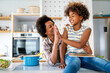 © NDABCREATIVITY - Happy african american single mother helping child with distance education. Online education