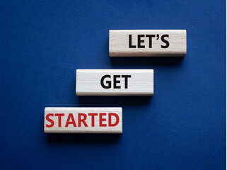 Wall Mural - lets get started symbol. concept words lets get started on wooden blocks. beautiful deep blue backgr