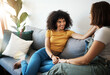 © aLListar/peopleimages.com - Discussion, love and lesbian couple relaxing on a sofa in the living room talking and bonding. Happy, conversation and young interracial lgbtq women speaking and resting together in lounge at home