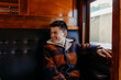 © Austockphoto - Young boy sitting beside window on train