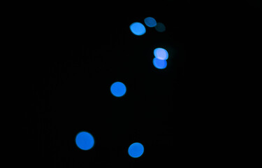 Wall Mural - bokeh, blue dots and black background with glow or sparkle, mockup space with light, texture and fla