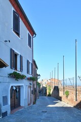 Canvas Print - A street in the medieval quarter of Torrita di Siena, a village in Tuscany in Italy.