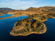 © Austockphoto - Campsite and campgrounds on headland jutting into blue water of water catchment lake