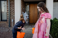 Two Children Dressed Up For Halloween Ready To Trick Or Treat; A Boy Werewolf & Vampire Princess