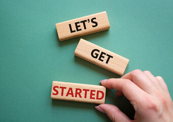Wall Mural - lets get started symbol. concept words lets get started on wooden blocks. beautiful grey green backg