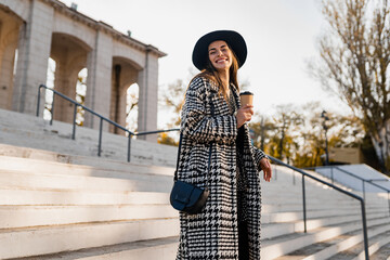 attractive young woman walking in autumn wearing coat