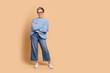 © deagreez - Full size photo of attractive senior woman crossed hands posing dressed stylish blue knitted clothes isolated on beige color background