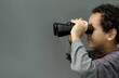 © herlanzer - boy looking  through binoculars on grey background with people stock image stock photo